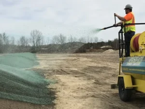 Custom Exterior Landscape crew hydroseeding after recent regrading of commercial property